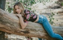 Katie Koniakowsky lying on tree