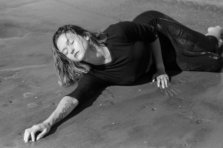 Caity Rose lying in the sand